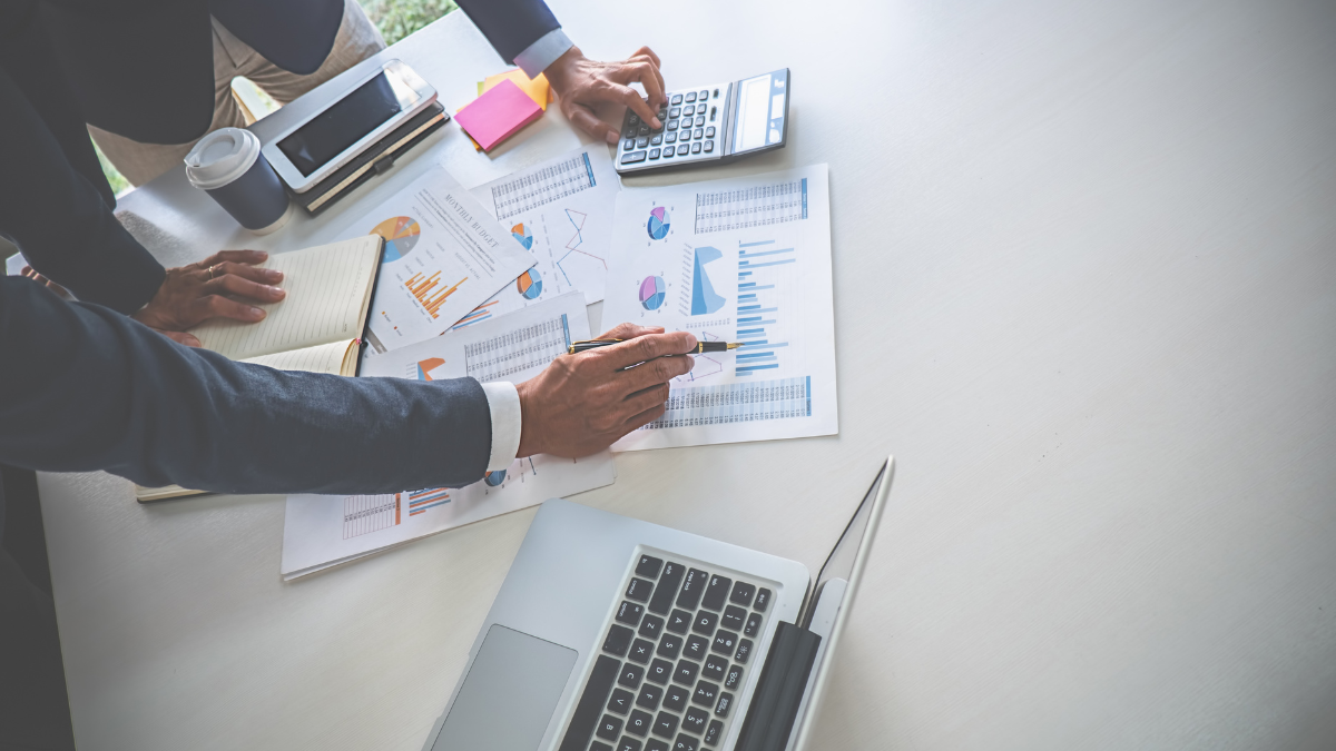Colleagues pointing at a kanban board